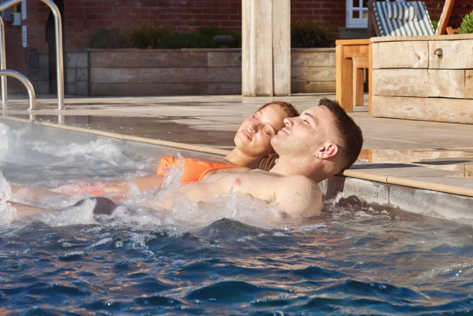An image of two people in the outdoor pool at Eden Hall