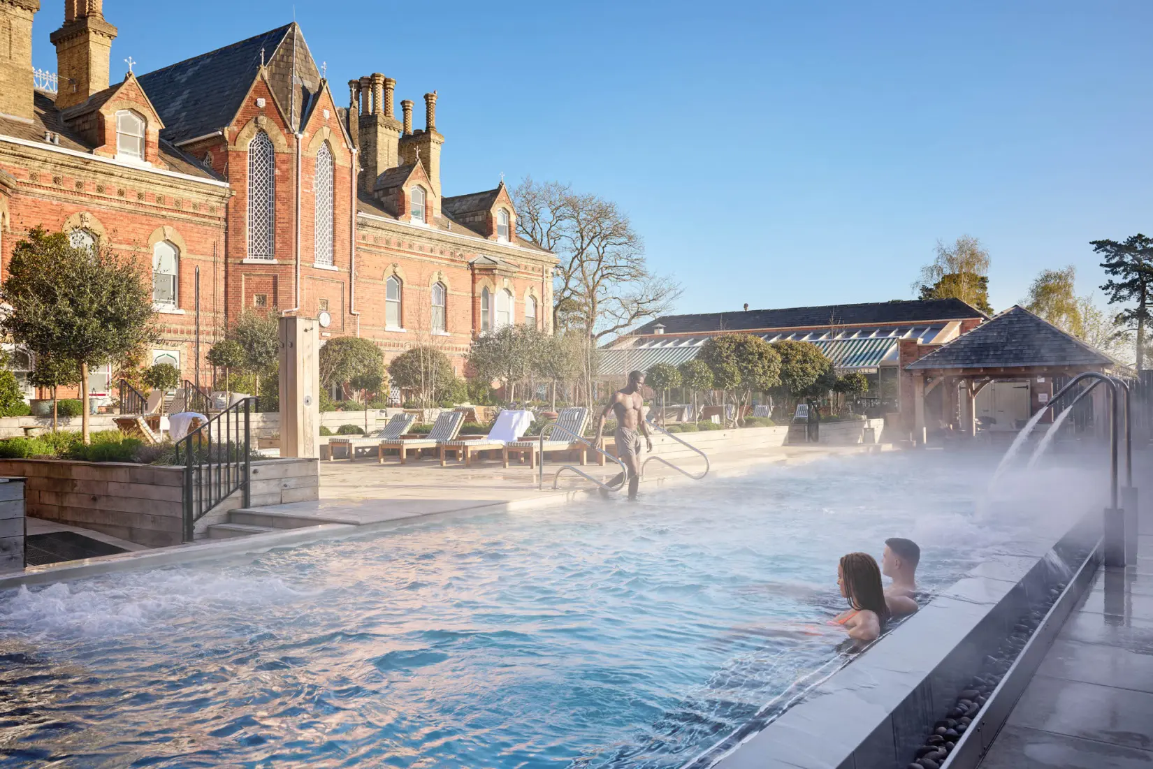 An image of the outdoor pool with people in at Eden Hall