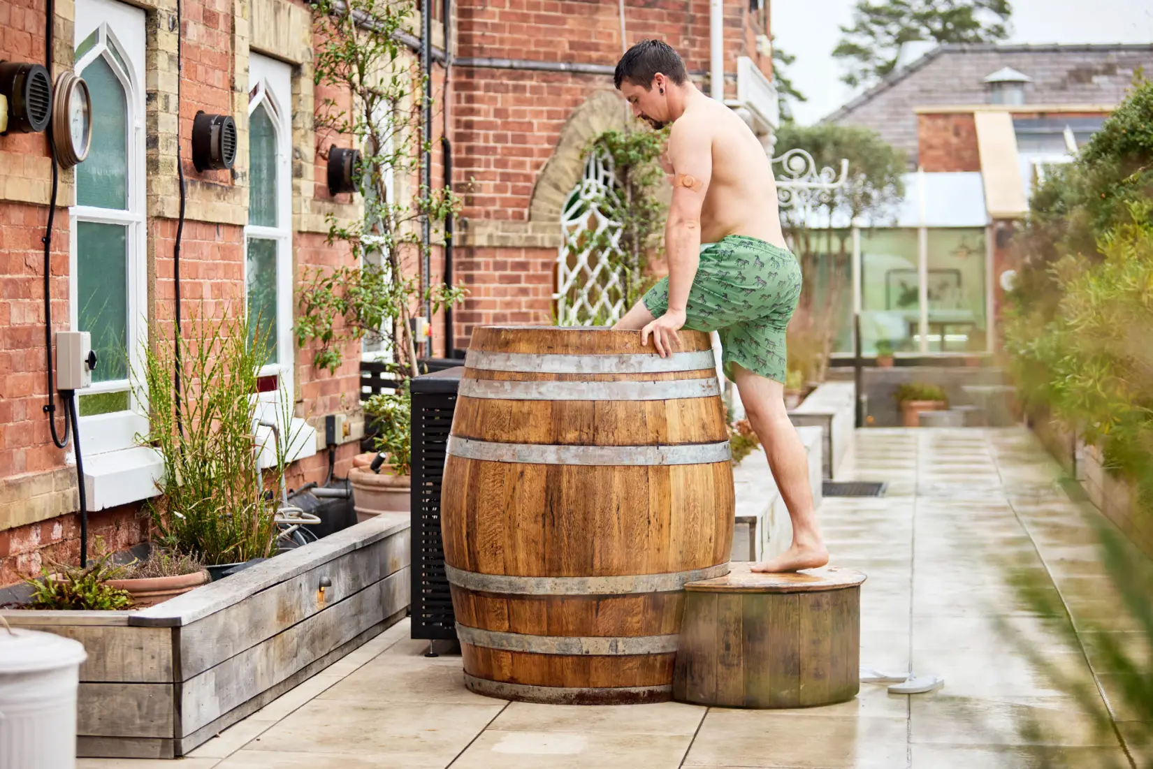 An image of a man getting into a barrel at Eden Hall