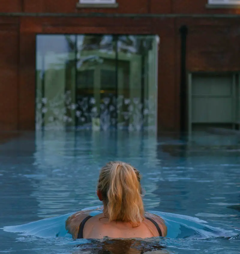 An image of a woman in the outdoor pool at Eden Hall