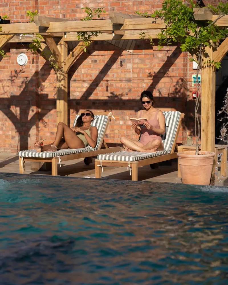 An image of women sun bathing at Eden Hall