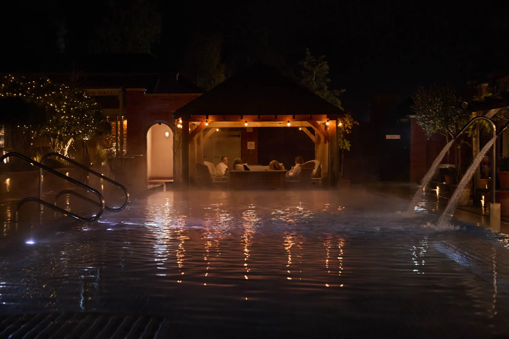 An image of women in the outdoor pool at night at Eden Hall