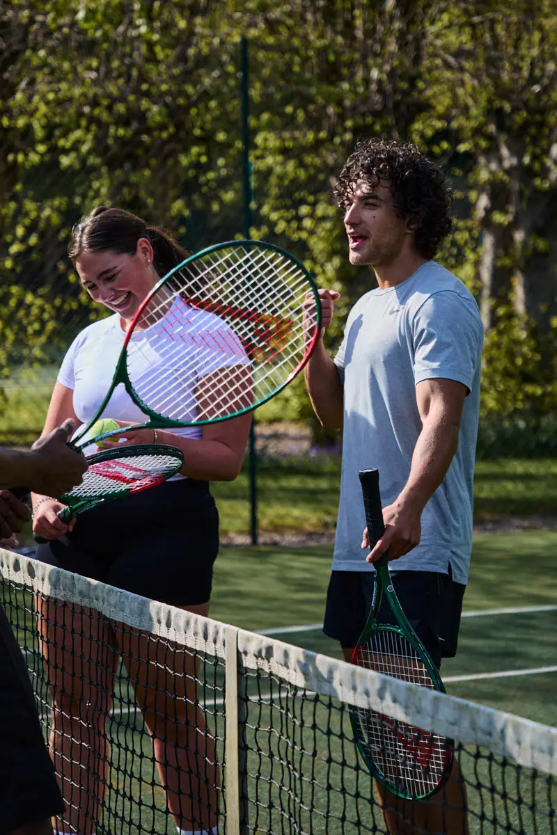 An image of people playing tennis at Hoar Cross Hall