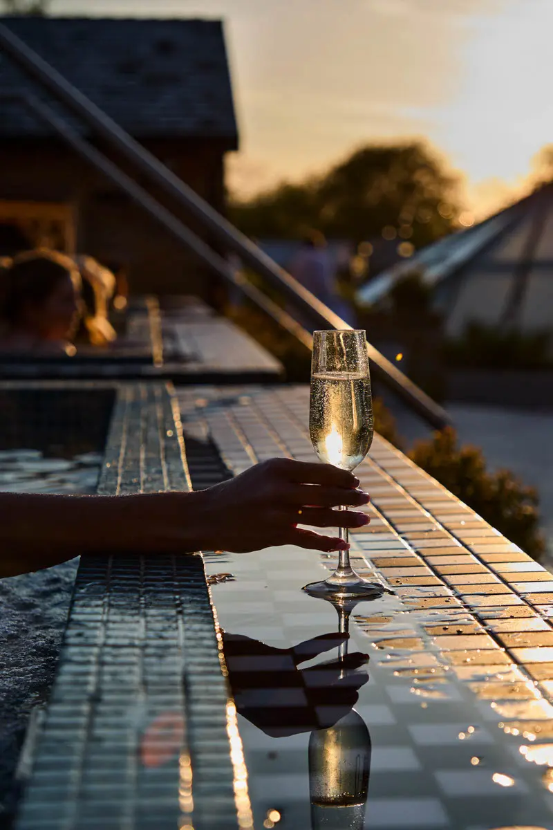 An image of a glass of alcohol on the hot tub at spa terrace at Hoar Cross Hall