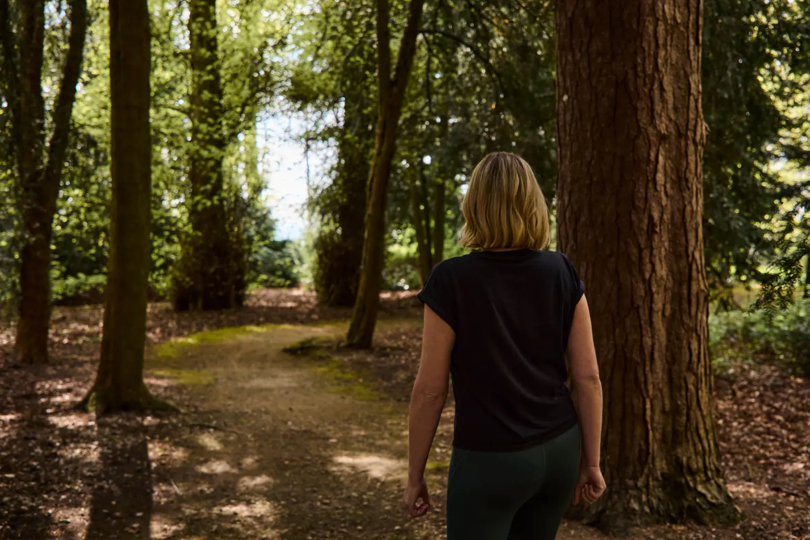 An image of a woman bathing in the forest sun at Hoar Cross Hall