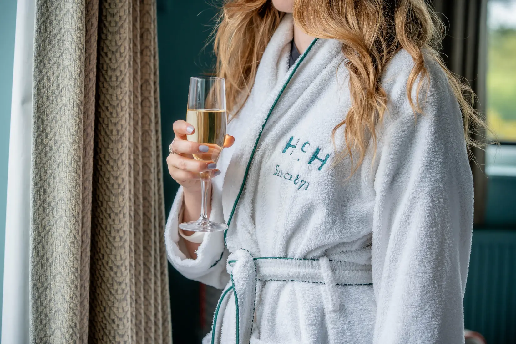 An image of a woman drinking in one of the rooms at Hoar Cross Hall
