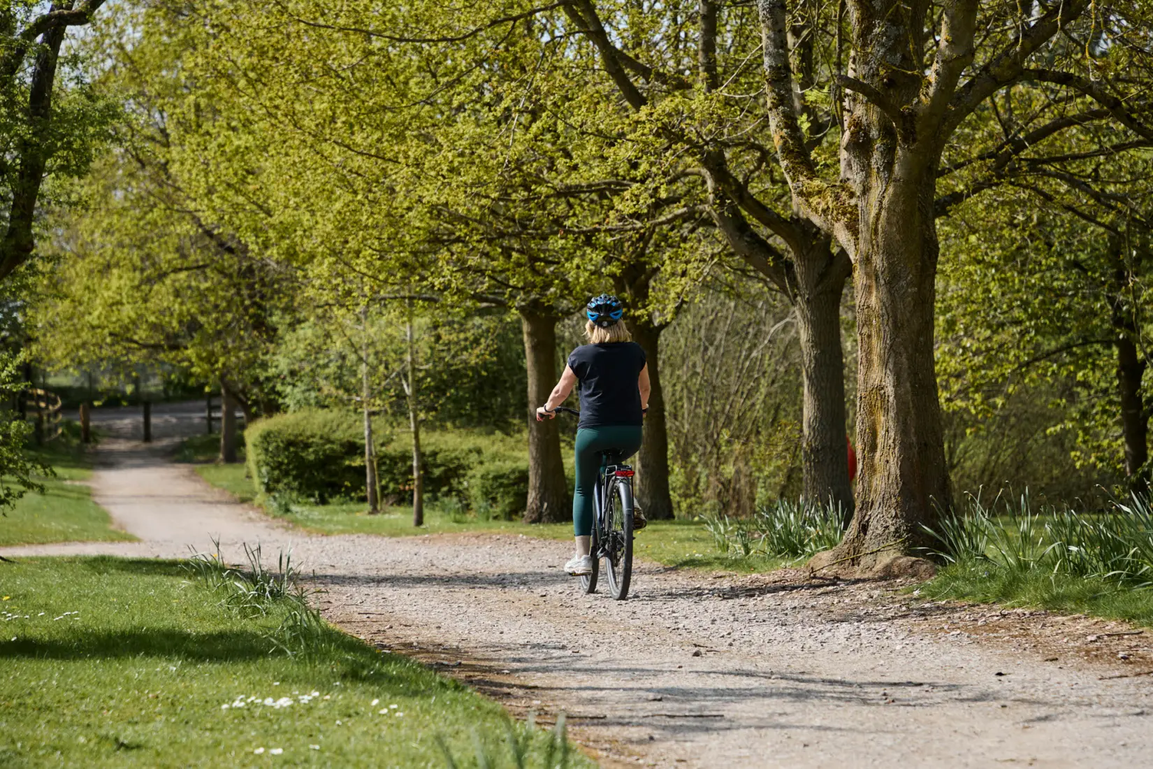 An image of a woman cycling at Hoar Cross Hall