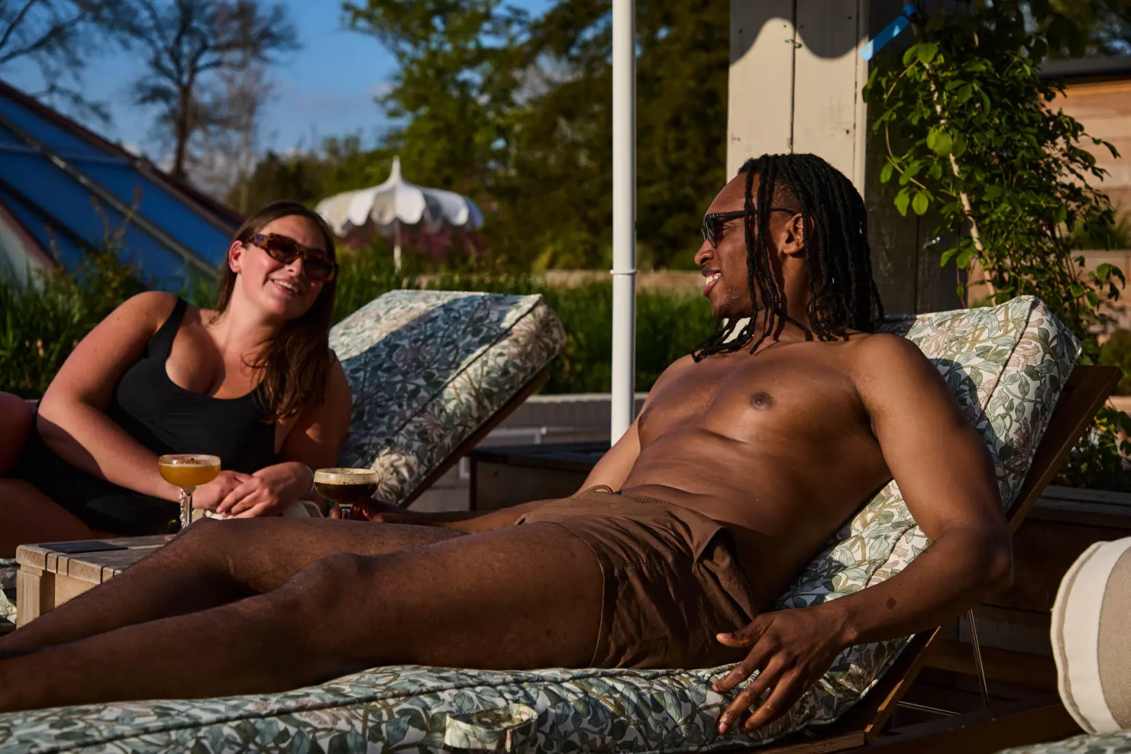 An image of two people on the terrace sun loungers at Hoar Cross Hall