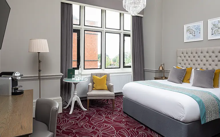 Comfy room at Hoar Cross Hall with a plush bed, soft furnishings, and classic décor.