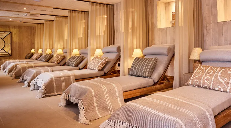 Image of loungers in a softly lit room with blankets folded