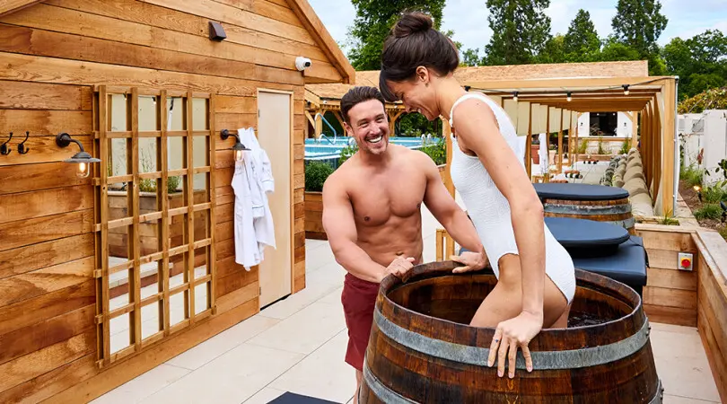 Image of woman getting into a cold plunge barrel at Hoar Cross Hall