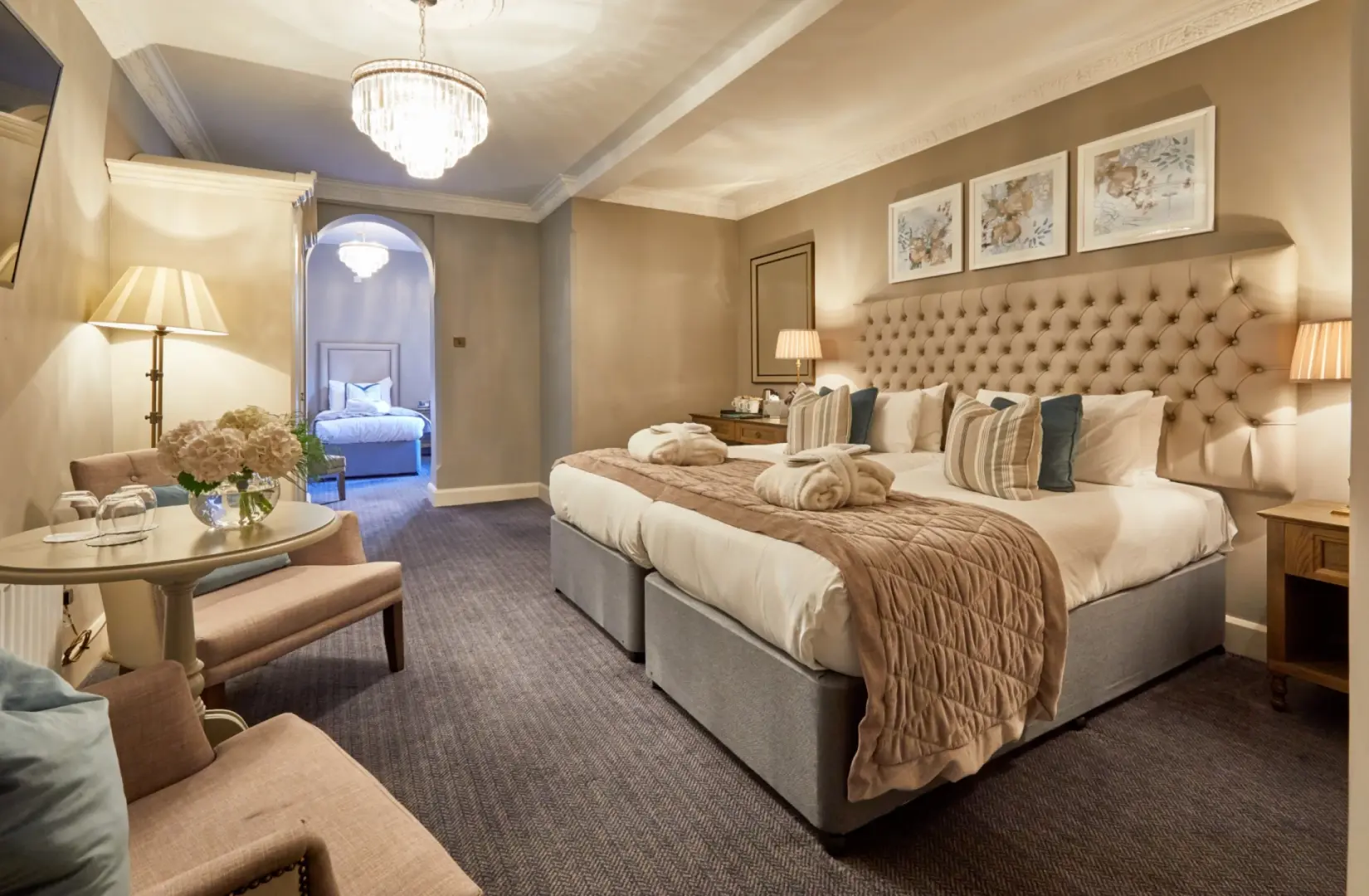 Comfy room for three at Hoar Cross Hall with a plush bed, soft furnishings, and classic décor.