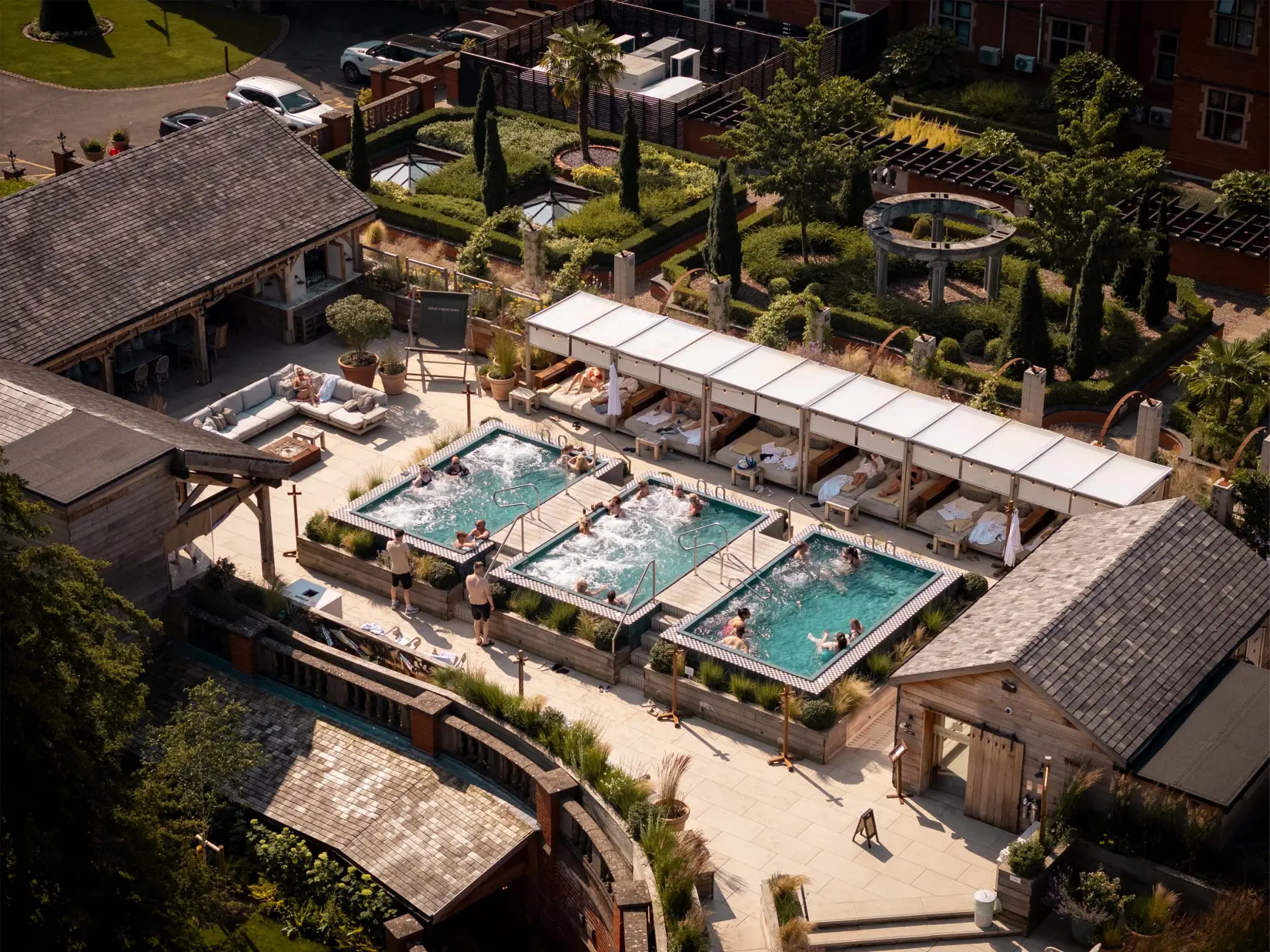 Outdoor spa terrace with loungers and landscaped gardens creating a peaceful setting for relaxation.